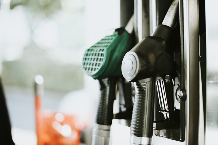 Fuel pump nozzle dispensing ethanol, representing renewable biofuel derived from corn.