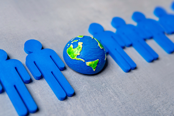 Blue gear with green sustainability symbol representing ESG integration in industrial and corporate operations.