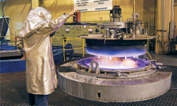 Industrial furnace used for controlled heat treatment of large mechanical components in heavy manufacturing.