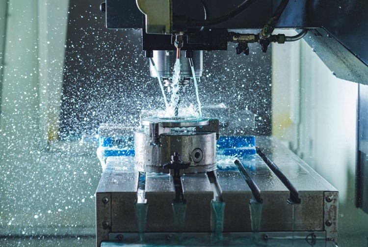 CNC machining process manufacturing a precision metal component in an industrial production facility.