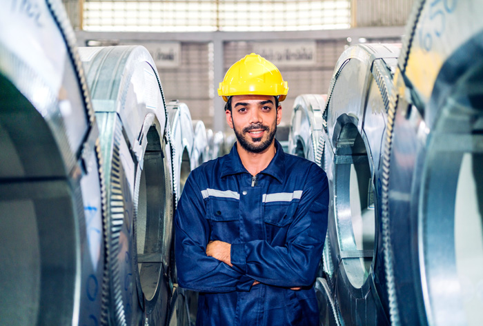 Maintenance professional inspecting industrial equipment, highlighting condition monitoring and predictive maintenance practices in manufacturing environments.