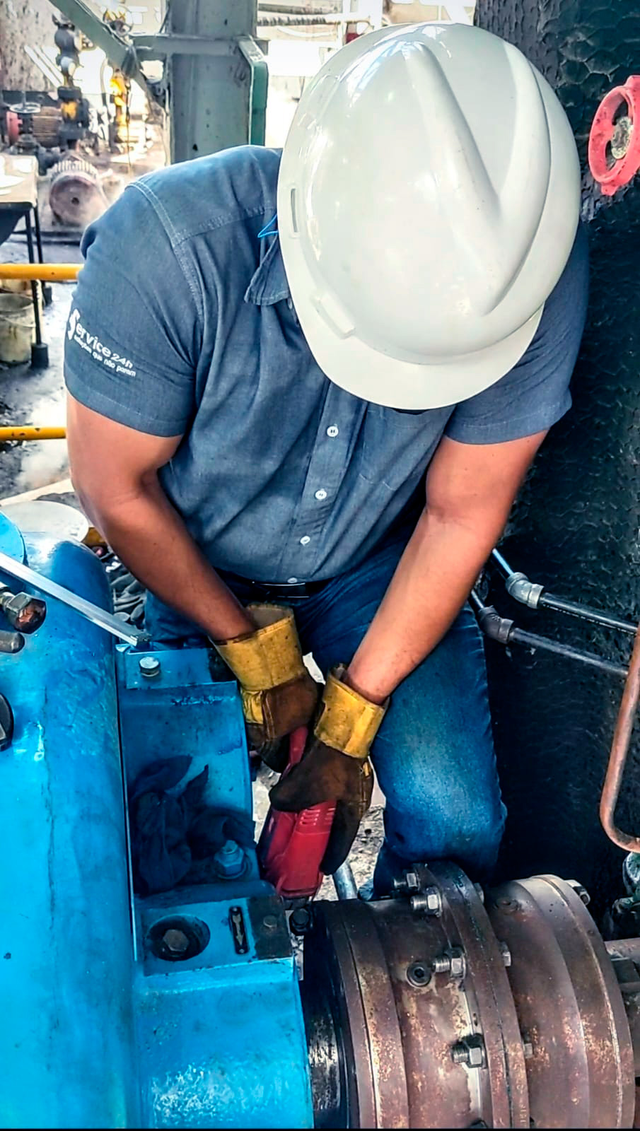 Maintenance technician performing preventive maintenance on industrial equipment as part of a scheduled maintenance plan.